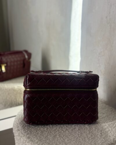 Braided burgundy clutch